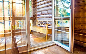 French doors open onto a balcony with a view of leafy green trees. nature. relax concept. vocations