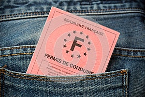 French driving license in the rear pocket of blue jeans, driving licence concept photo