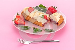 French eclair grazed with chocolate and fruity strawberry cream or sweet Italian profiteroles and fresh juicy strawberries, food