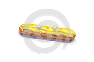 French eclair with yellow icing on  background.