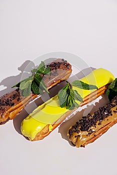 French eclairs with choclate top and different fillings. Traditional recipe, French cuisine.