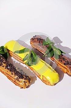 French eclairs with choclate top and different fillings. Traditional recipe, French cuisine.