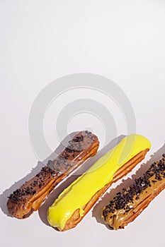 French eclairs with choclate top and different fillings. Traditional recipe, French cuisine.