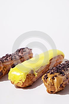 French eclairs with choclate top and different fillings. Traditional recipe, French cuisine.