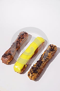 French eclairs with choclate top and different fillings. Traditional recipe, French cuisine.