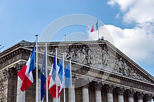 French and European flags in the wind in front of National Assem