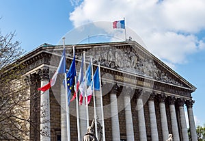 French and European flags in the wind in front of National Assem