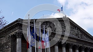 French and European flags in the wind in front of National Assembly