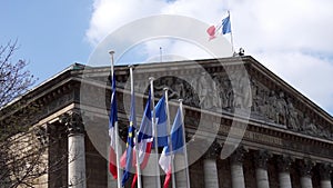 French and European flags in the wind in front of National Assembly