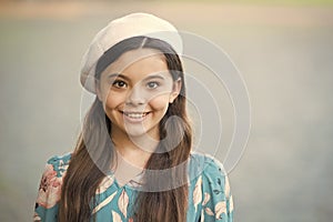 French fashion icon. Happy kid wear french beret grey background. French look of little girl. Small child in french
