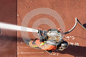 French firefighter with fire hose shot from above