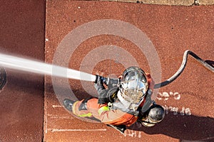 French firefighter with fire hose shot from above