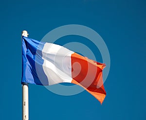 French flag against blue sky