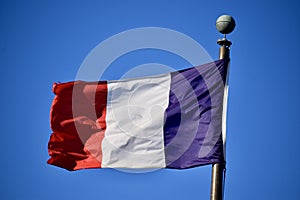 French Flag against a blue sky. Yorktown, VA, USA.