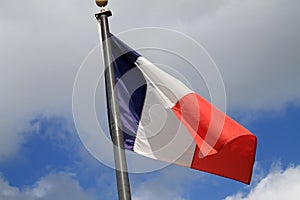 French flag flying on pole in daytime