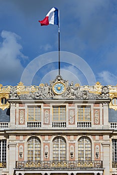 French flag in top of Palace Versailles near Paris