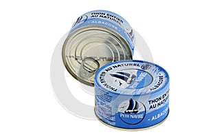 Cans of Petit Navire brand natural tuna close-up on white background
