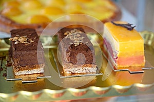 French fresh baked sweet pastry with chocolate, fresh fruits and berries in confectionery shop close up