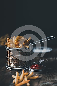 French fries in a basket with ketchup