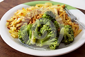 French fries and broccoli on white plate