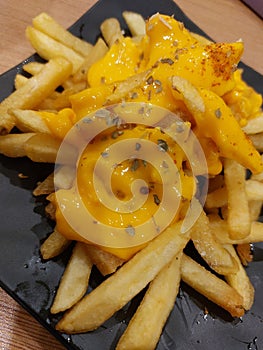 French fries with cheese sauce and a litle chili powder