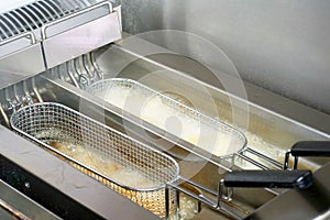 French fries in deep fryer, closeup