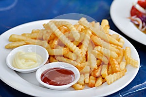 French fries or fried potato with tomato sauce and mayonnaise