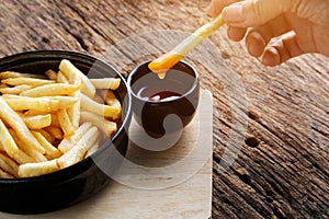French fries with ketchup on a dark wood background. fastfood snack