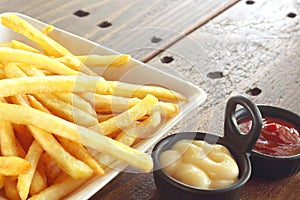 French fries with ketchup and mayonnaise, top view of potato fry