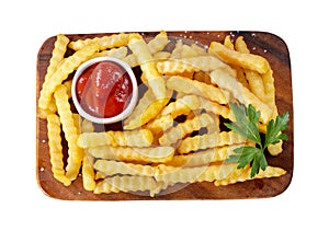 French fries with ketchup on a wooden board isolated on white background