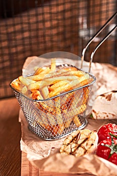 French fries in metal basket. Fast food set