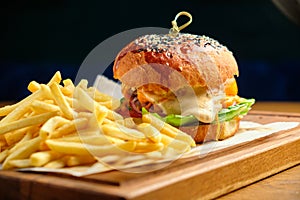 French fries next to a burger lying