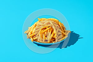 French fries plate minimalist on a blue background