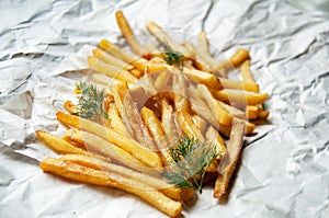 French fries Potatoes with dill sprigs on a white sheet