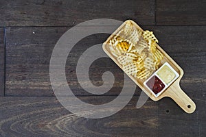 French fries served with ketchup on the wooden desk