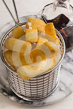 French fries in a serving basket, served with malt vinegar