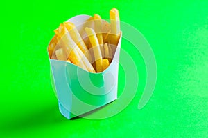 French fries straws in white box on green background