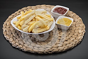 French fries on Table mat with catchup & mustard sauce