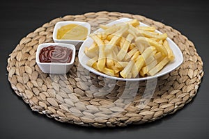 French fries on Table mat with catchup & mustard sauce