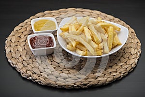 French fries on Table mat with catchup & mustard sauce