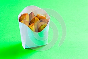 French fries in white box on green background