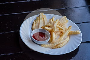 French fries on wooden Table with catchup