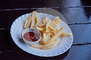 French fries on wooden Table with catchup