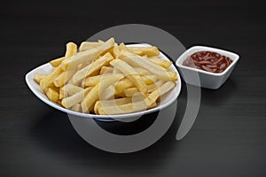 French fries on wooden Table with catchup