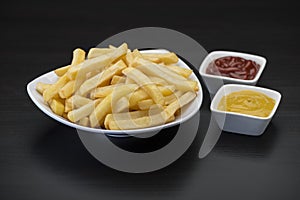 French fries on wooden Table with catchup