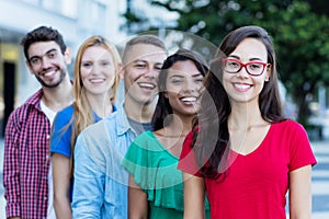 French girl with male and female young adults in line