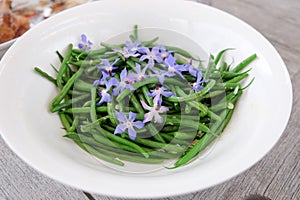 French green beans with edible blue borage flowers and garlic