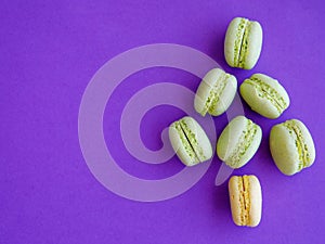 French green macarons shaped as Christmas tree on purple background. Top view