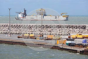 French harbor Calais with dredging ship navigating outside the h