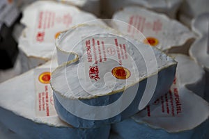 French heartshaped neufchatel cow cheese for sale in farmers dairy shop, french text on lables means Neufchatel cheese, made from